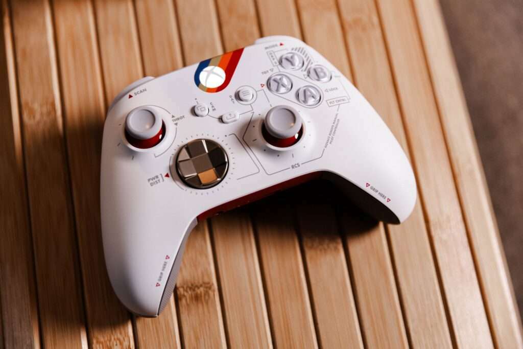 a white controller sitting on top of a wooden table